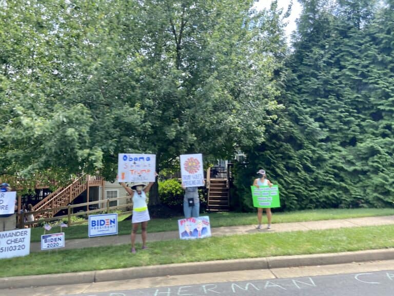 Trump was met with boos, protesters mocking his cognitive test, signs praising John Lewis, and blame for the death of Herman Cain en route to his golf club on Saturday.