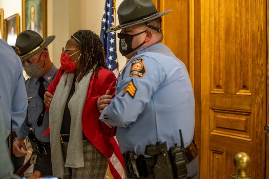 Police arrest Georgia state lawmaker as she knocks on Gov. Kemp's office door.