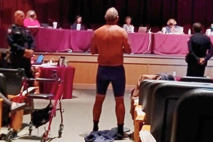 Texas father strips off clothing at school board meeting in support of mask wearing.