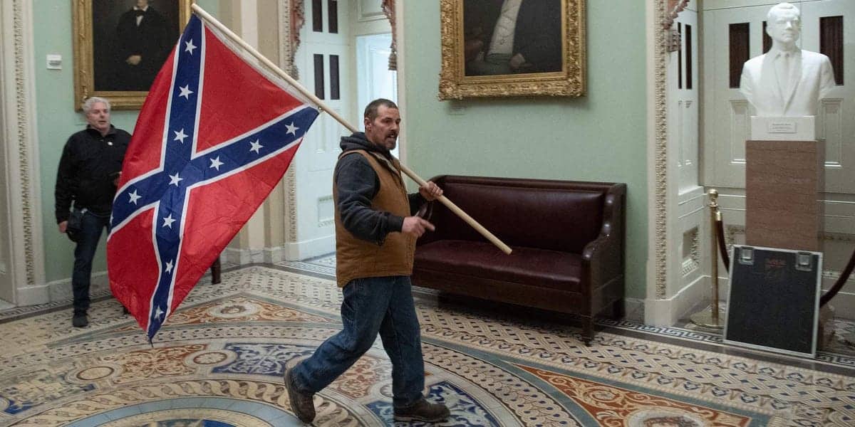 Confederate flag-toting man, son convicted in Capitol riot: Report.