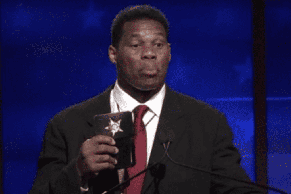 Debate moderator scolds Herschel Walker for flashing 'prop' badge in Georgia debate.