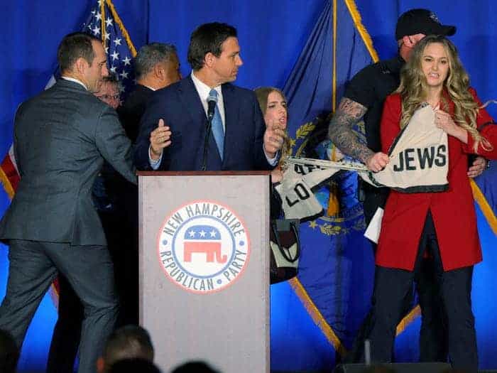 Protesters storm the stage during DeSantis speech in New Hampshire.