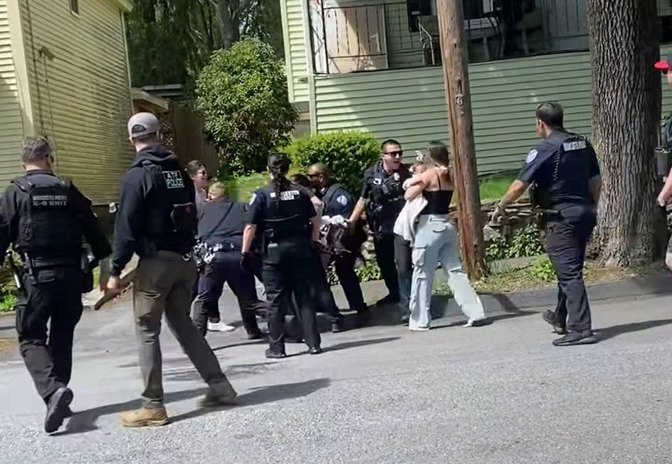Neighbors surround ICE agents trying to detain woman in Massachusetts.